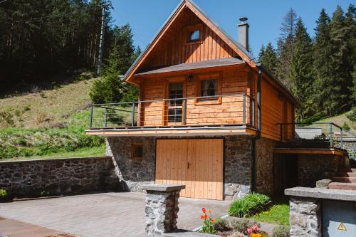 a wooden house with a large wooden garage at Chata JÚLIA in Vernár