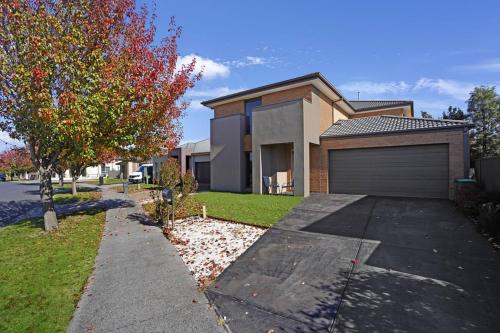 a house with a garage in front of it at Modern Pakenham Family Home near Lakeside in Pakenham