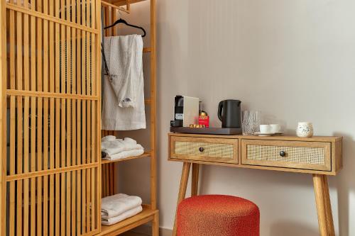 a room with a wooden table and a chair at Lotus Rise Hotel - Adults Only in Hersonissos