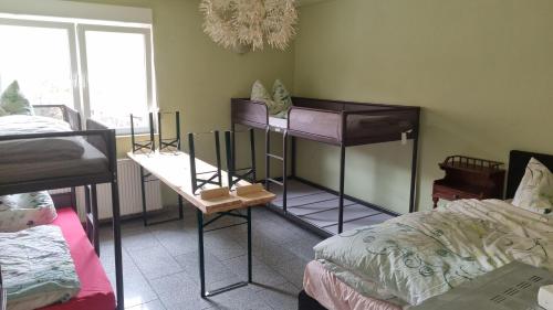 a room with two bunk beds and a bed at Gästezimmer Lea mit Gemeinschaftsbad in Hausbreitenbach