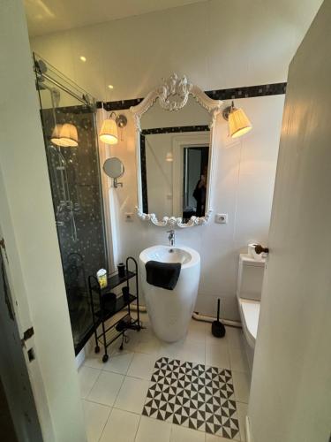 a bathroom with a tub and a sink and a shower at Demeure Arcachonaise de charme in Arcachon