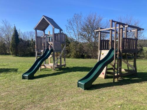 three playground slides in a park with grass at Kliff Butiik Majutus & Restoran in Panga