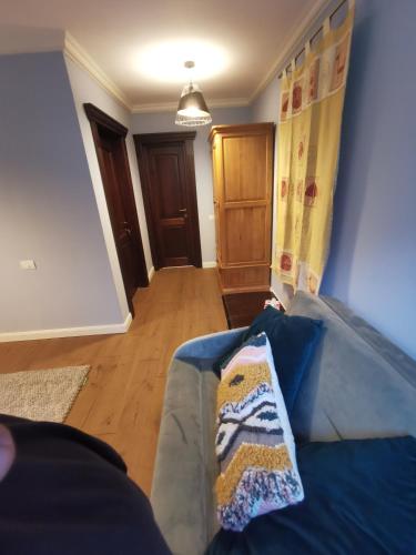 a living room with a couch with a blanket on it at Yellow House in Bran