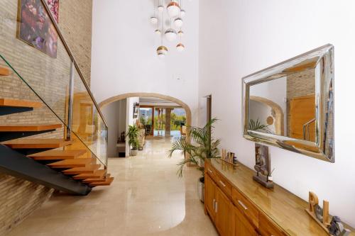 a hallway with a staircase and a mirror at Casa Tranquila in Jávea