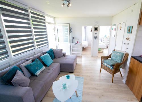 a living room with a couch and a table at K145 The Retreat at Camber Sands in Camber