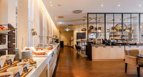 a large kitchen with a lot of food on display at Holiday Inn Dresden - Am Zwinger, an IHG Hotel in Dresden