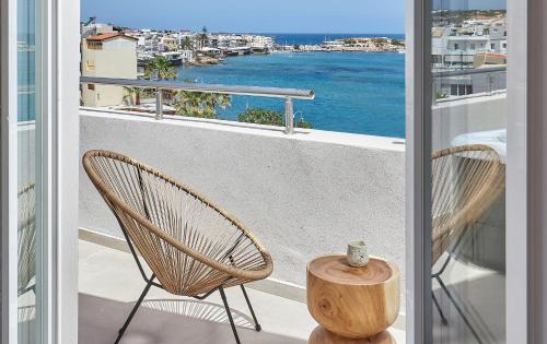 a balcony with two chairs and a view of the ocean at Lotus Rise Hotel - Adults Only in Hersonissos