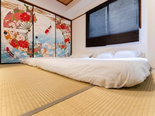 a bedroom with a large white bed with a window at Shinjuku,Ushigome Yanagicho Sta 1min walk , Kabukicho3min in Tokyo