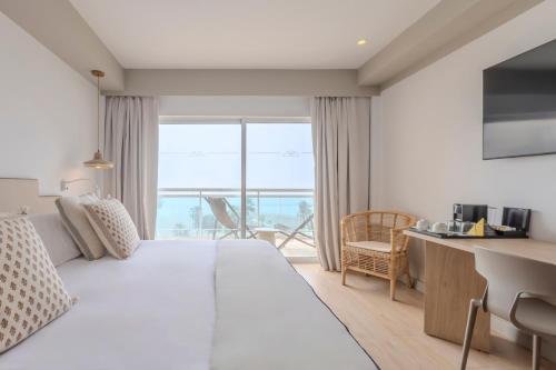 a hotel room with a bed and a desk and a window at Soho Boutique Las Vegas in Málaga