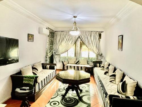 ein Wohnzimmer mit Sofas und einem Tisch in der Unterkunft Sary's Hotel in Mʼdik