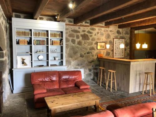 un salon avec un canapé et un bar dans l'établissement Le Chevalier - Maison et jardin face à la montagne, à Saint-Vincent