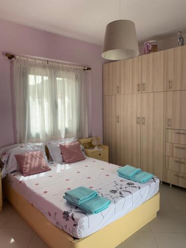 a bedroom with a bed with two towels on it at For a good hospitality in Souvala