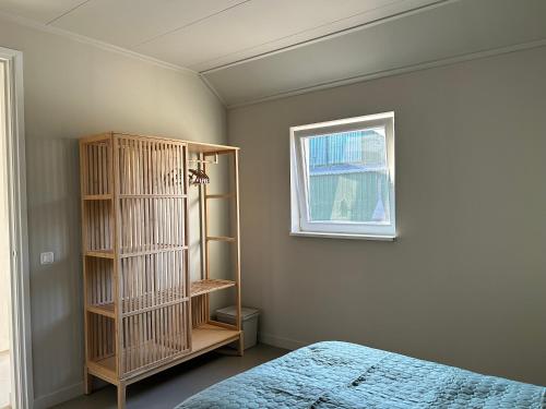 a bedroom with a book shelf next to a bed at Buitenplaats Ureterp in Ureterp