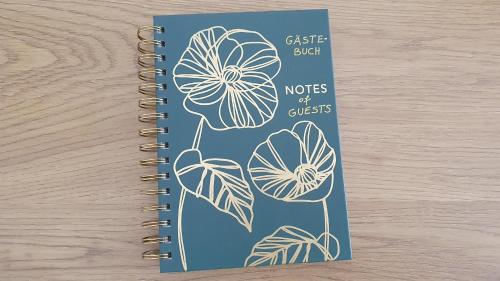 a spiral notebook with a drawing of flowers at Kienreich Apartments Görlitzer Innenstadt in Görlitz