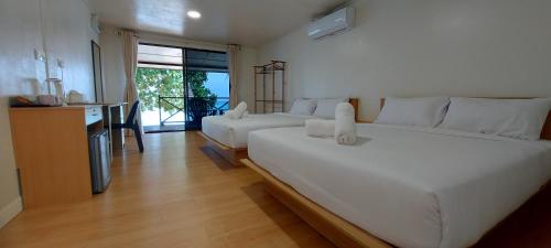 a bedroom with two beds and a living room at Home Away Tioman Island in Tioman Island
