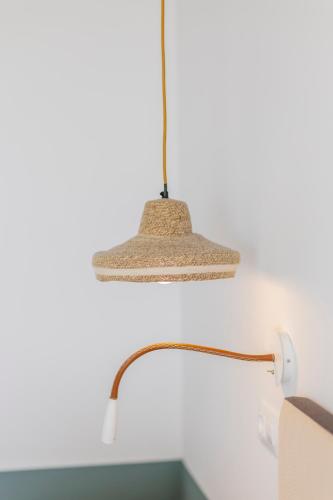 a lamp hanging from a wall next to a desk at Soho Boutique Las Vegas in Málaga