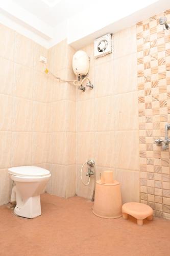 a bathroom with a toilet and a shower at Hotel Anand Inn in Vapi