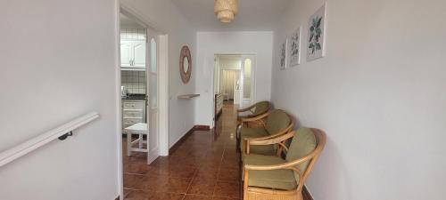 a hallway with chairs and a kitchen in a room at Sabbia Suites Casa San Miguel in Teguise