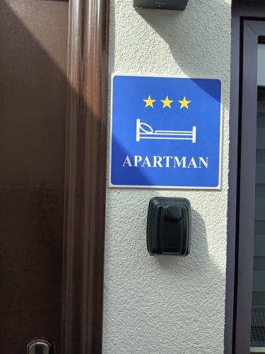 a blue sign on a building with stars on it at PETRA in Ðakovo