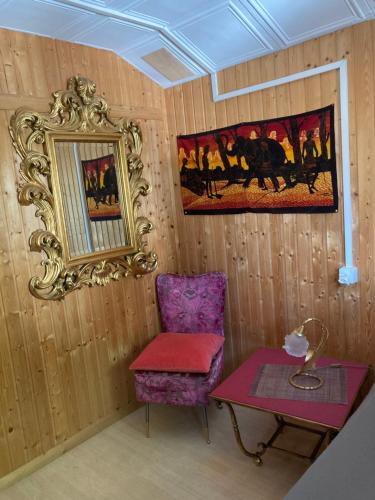 a room with a chair and a table and a picture at BnB122 bed&breakfast in Ascona