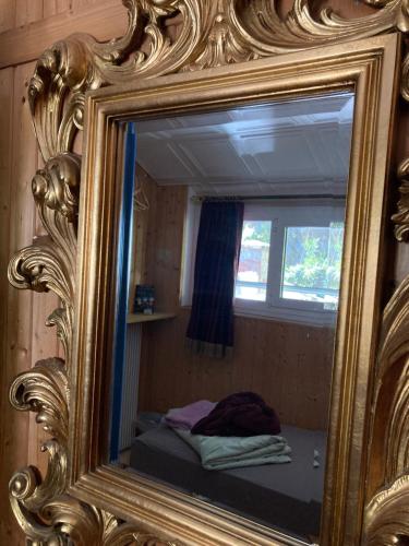 a mirror reflection of a bed in a room at BnB122 bed&breakfast in Ascona