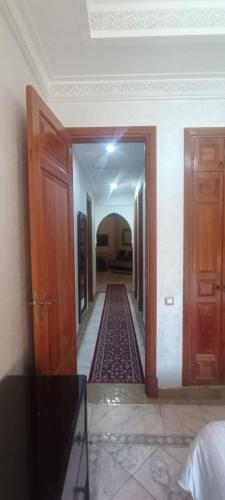 a hallway in a house with two doors and a carpet at Les Jardins de la palmeraie in Marrakech
