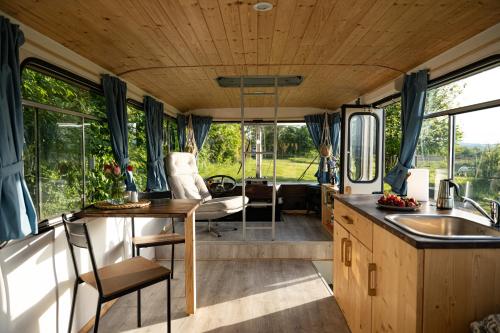 a kitchen and dining area of a camper van at Bus Ikarus in Prievidza