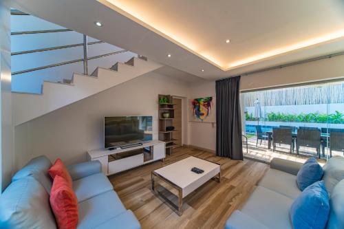 a living room with a blue couch and a television at villa Mojito in Koh Samui
