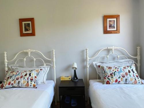 two beds sitting next to each other in a bedroom at YF Home Sweet Home FREE WIFI 4 bedroom beautiful house in Craigieburn