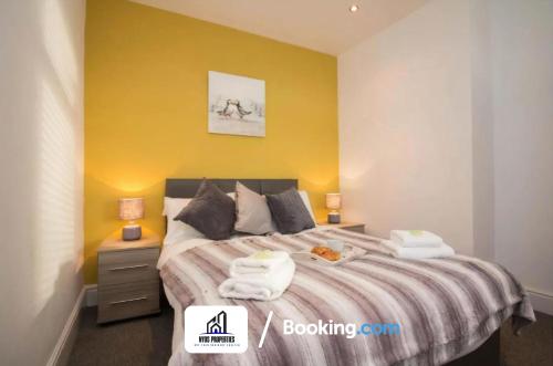 um quarto com uma cama com duas toalhas em Modern 3 bed Terraced House By NYOS PROPERTIES Short Lets & Serviced Accommodation Manchester With Free WiFi em Manchester