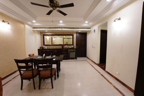 a dining room with a table and chairs and a ceiling fan at Shree Vallabh Vilas Lords Plaza Nathdwara - Pure Veg in Eklingji