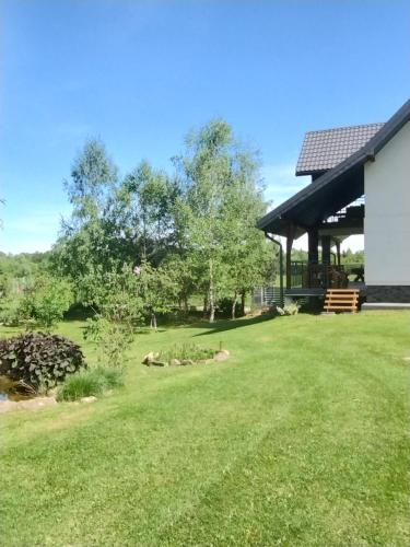 a yard with a pavilion in the background at Apart Home Bieszczady in Uherce Mineralne