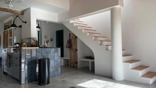 a white staircase in a room with a kitchen at Malhada do Sao in Tavira