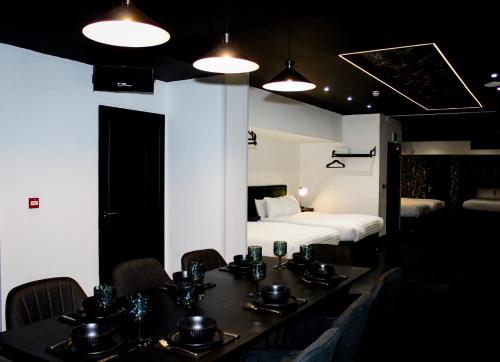 una habitación con una mesa y sillas y una cama en The Hideaway by Boutique 56, en Liverpool