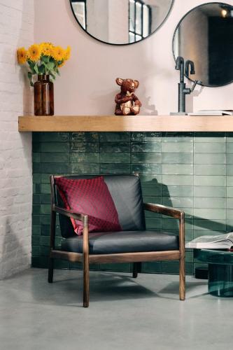 a chair in front of a counter with a mirror at Cousins Boutique Hotel in Maastricht