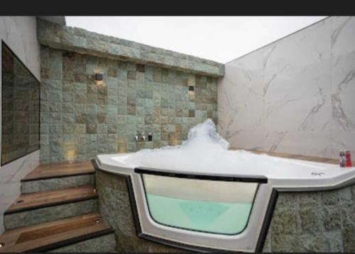 a bathroom with a bath tub with snow in it at Motel Desireé in Sao Paulo