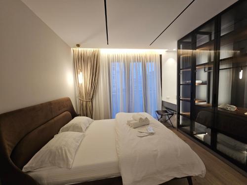 a small bedroom with a bed and a window at Center Apartment Easy_Luxury in Tirana