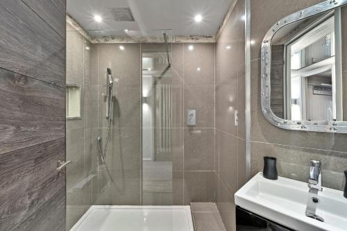 a bathroom with a shower and a sink at Finest Retreats - The Old Library in Dartmouth