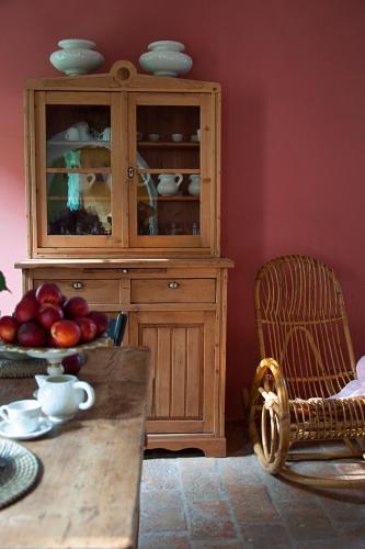 a wooden cabinet with a bowl of fruit on a table at BORGO GIUSTINIANI Mora Pero Melo in San Martino di Venezze