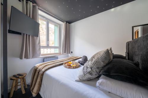 une chambre avec un lit avec un bol de fruits dessus dans l'établissement Le Modania - Modane Gare - A 15 mn des pistes, à Modane