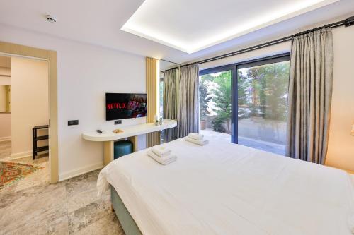a bedroom with a large bed and a window at Sole Vista Homes in Kas