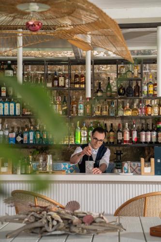 a man sitting at a bar looking at his cell phone at MelRose Relais in Massa Lubrense