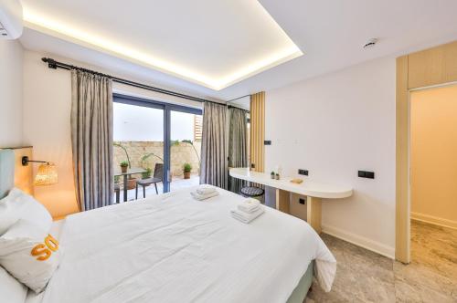 a bedroom with a bed and a desk and a window at Sole Vista Homes in Kas