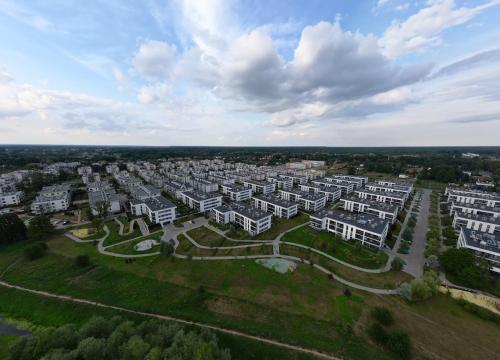 an aerial view of a city with white buildings at Lenki apartamenty Białołęka in Warsaw