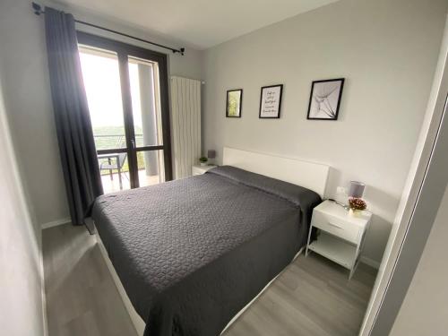 a small bedroom with a bed and a window at Dolcevista Apartment in Massino Visconti