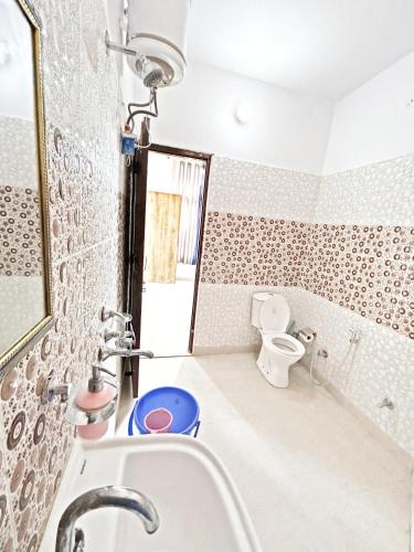 uma casa de banho com um lavatório e um WC em Home UbEx em Rishikesh