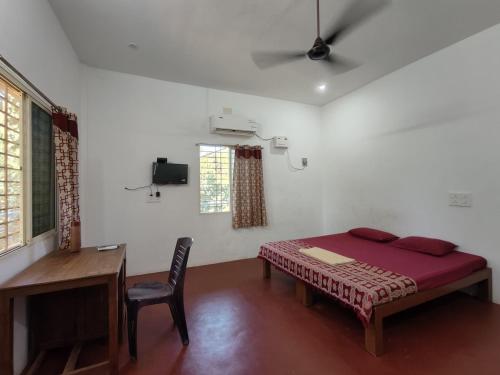 A bed or beds in a room at Chords of Nature Hostels & Hut Stays Pondicherry