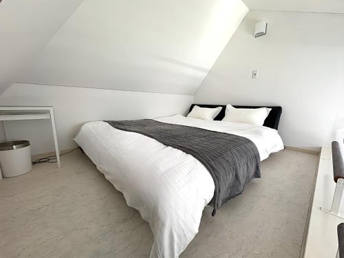 a bedroom with a large bed with white sheets at Nakameguro & Ikejiri-Ohashi 10min walk, Queen Bed, Switch, Free Wi-Fi, PocketWi-Fi in Tokyo