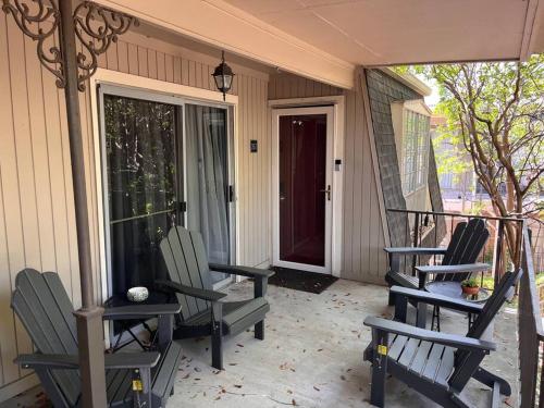 three rocking chairs sitting on the porch of a house at Healing Haven King Bed Suite in Dallas