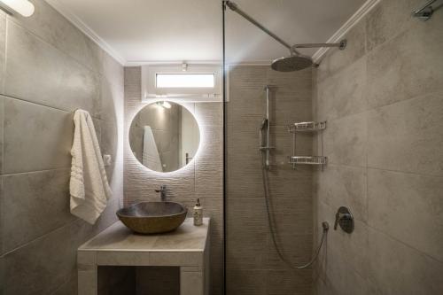 a bathroom with a sink and a shower with a mirror at Tranquil Retreat in Apokoronas - Chania in Kókkinon Khoríon